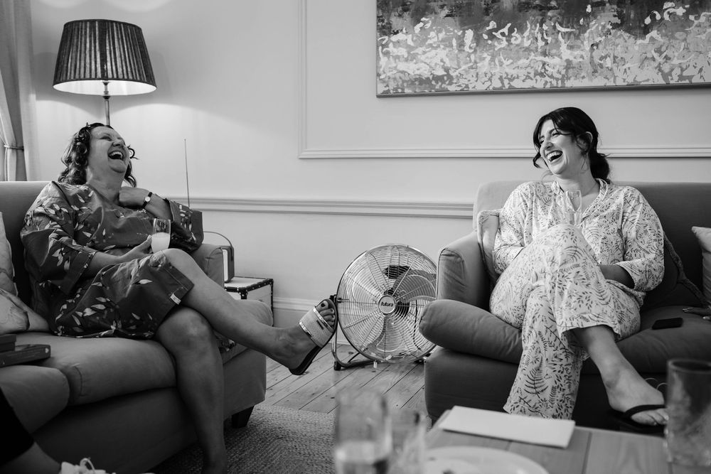 Black and white candid moment captured during wedding prep at Rivington Hall Barn captured by Lynette Matthews Photography