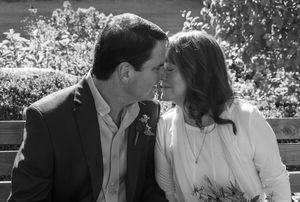 A black and white photo series showing romantic moments between a couple in a garden setting.