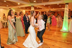 Wedding reception dance floor with warm lighting and wooden flooring.