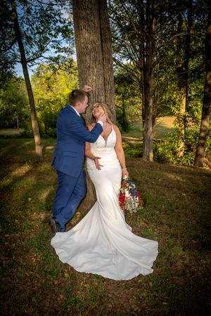 Romantic wedding portraits in a wooded setting during golden hour.