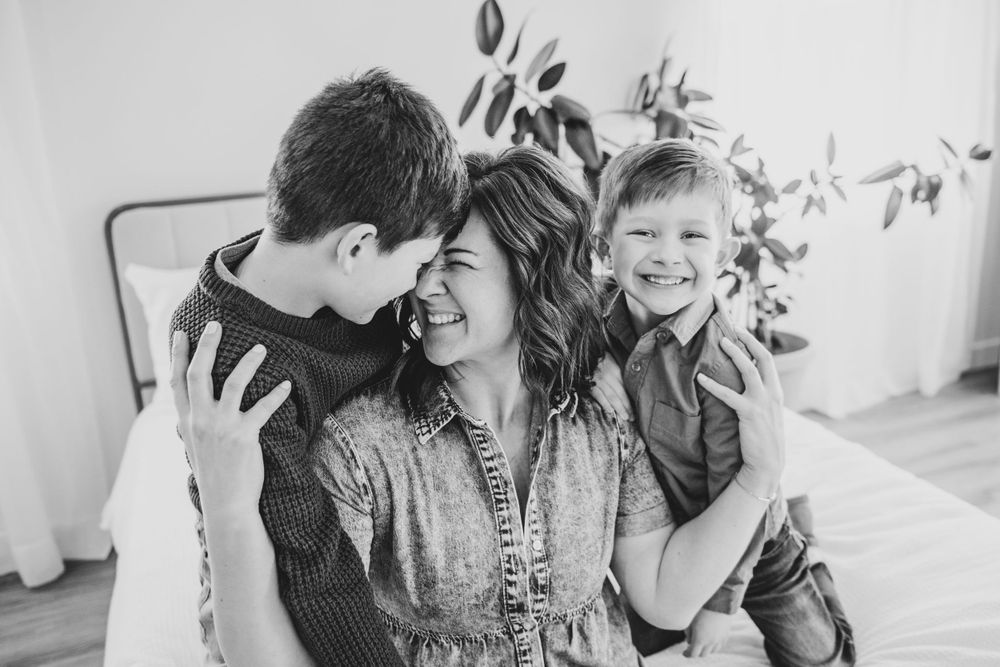 Black and white intimate family portrait showing joyful expressions and connection.