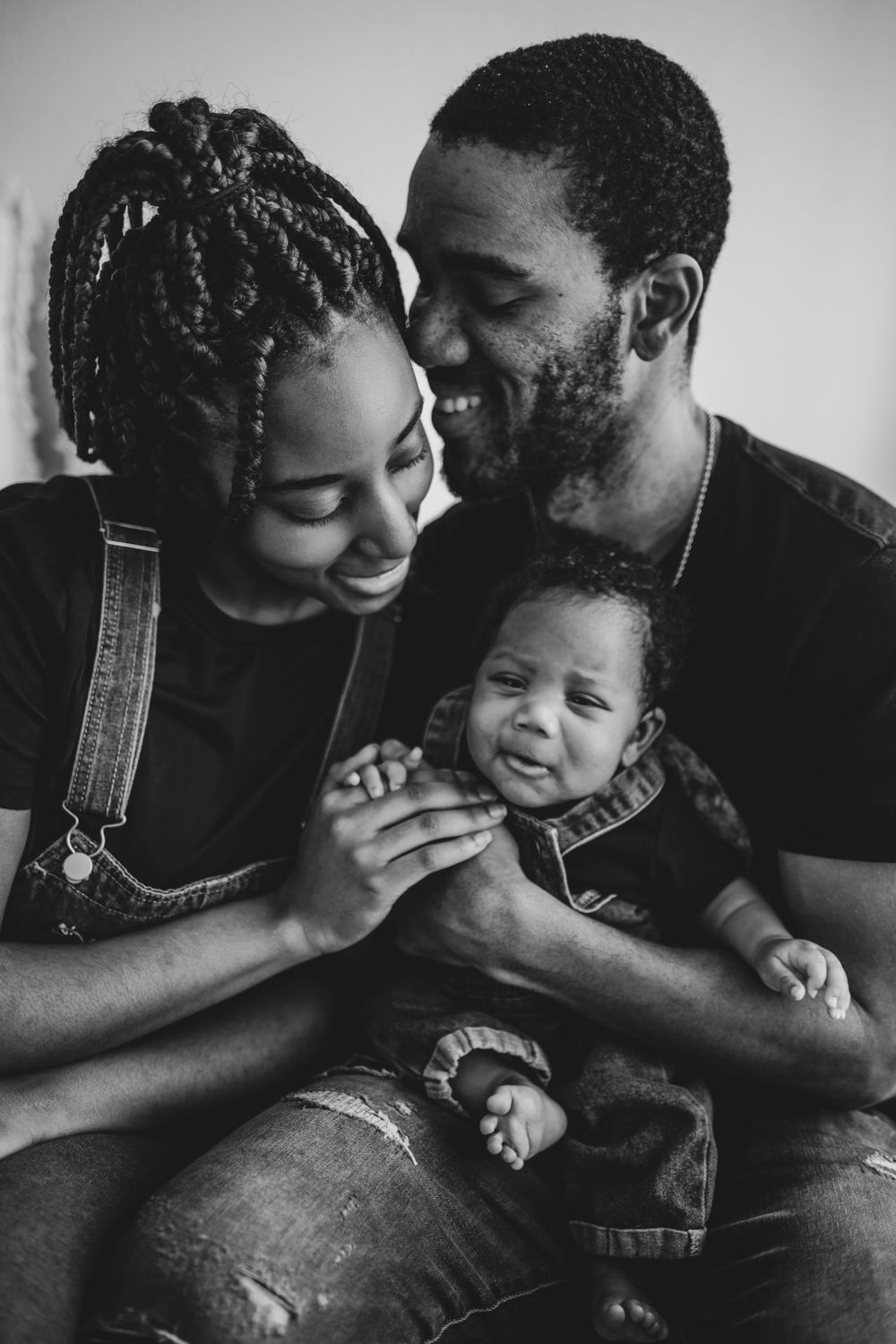 Black and white photo series capturing joyful moments and laughter between parent and child.