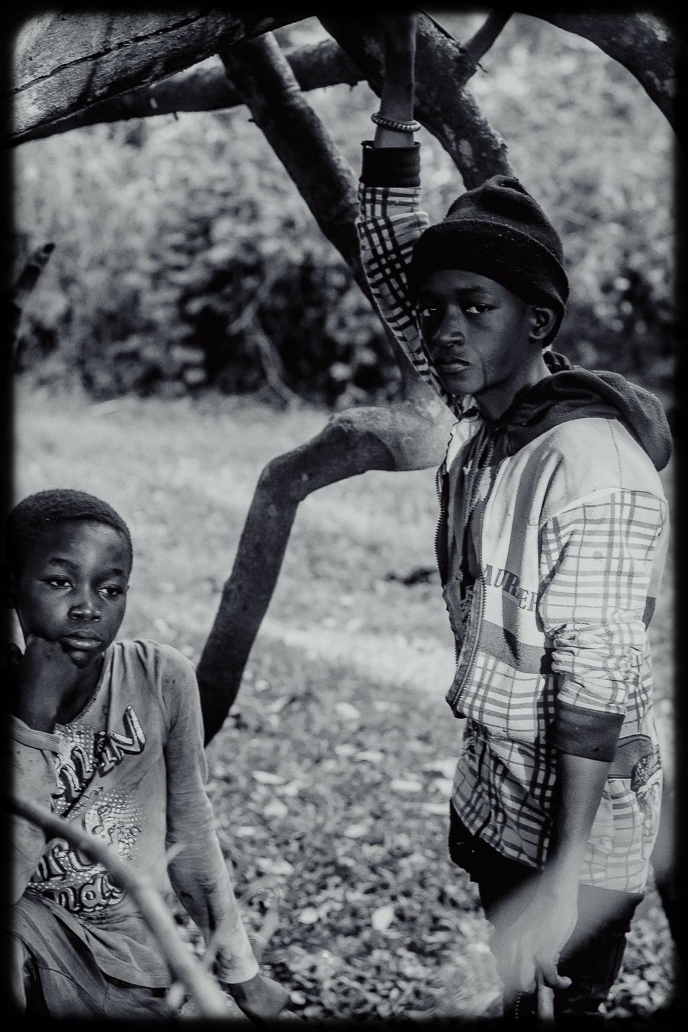 A sequence of black and white photographs showing children outdoors in casual attire looking off to the side.