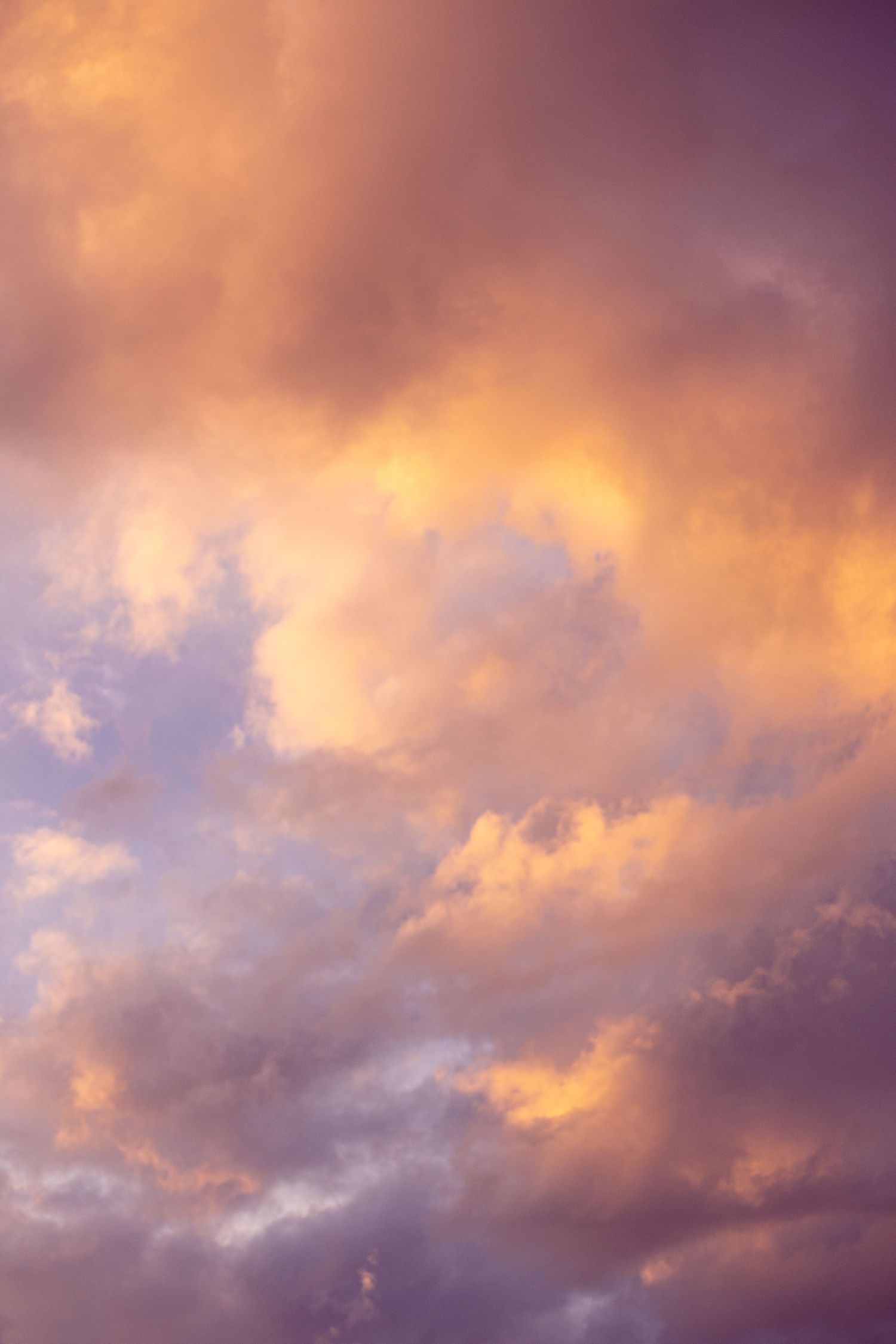 Dramatic orange and purple clouds fill sunset sky with vibrant colors.