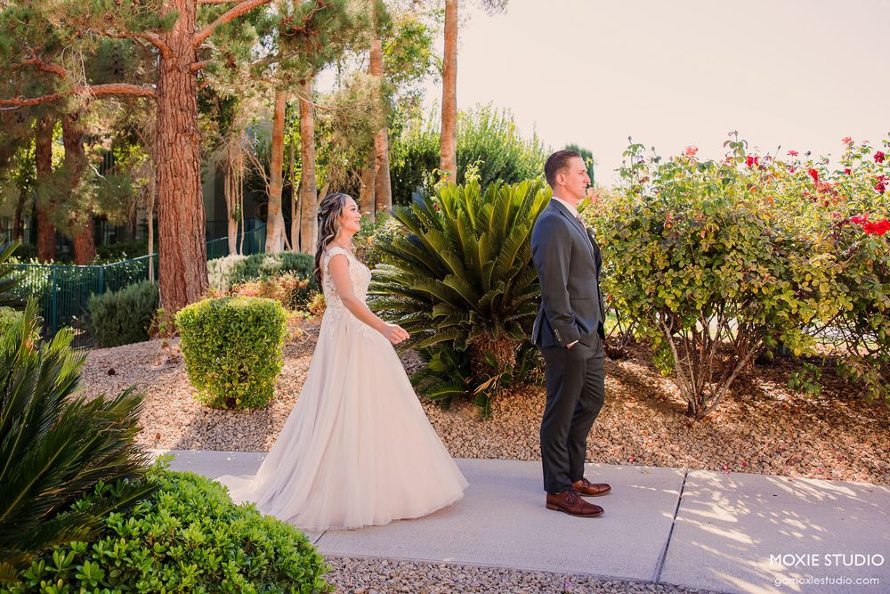 Romantic garden wedding photoshoot with couple surrounded by lush greenery and tall redwood trees at sunset.