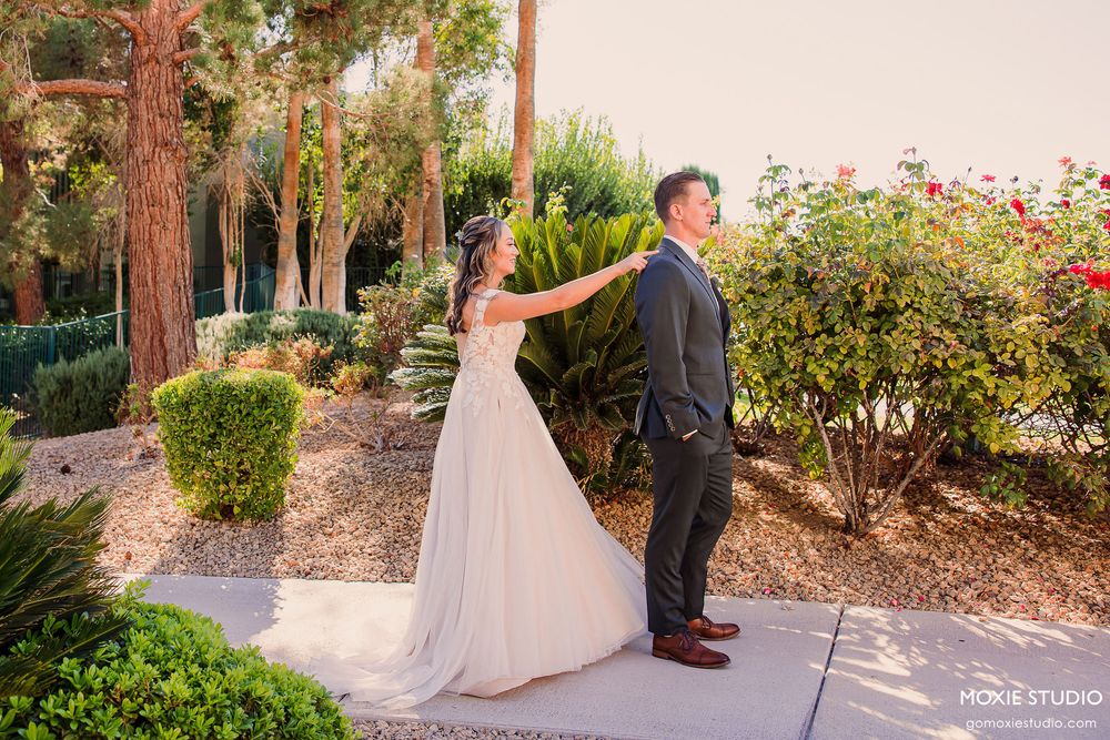 A romantic garden wedding scene with couples posing among lush greenery and trees.