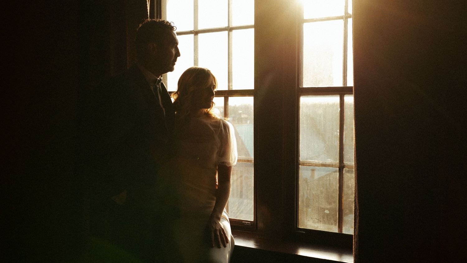 An intimate autumn wedding portrait of a couple on a rural road.