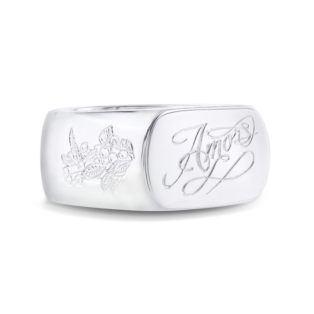 Polished silver signet ring with engraved design detail on wide band.