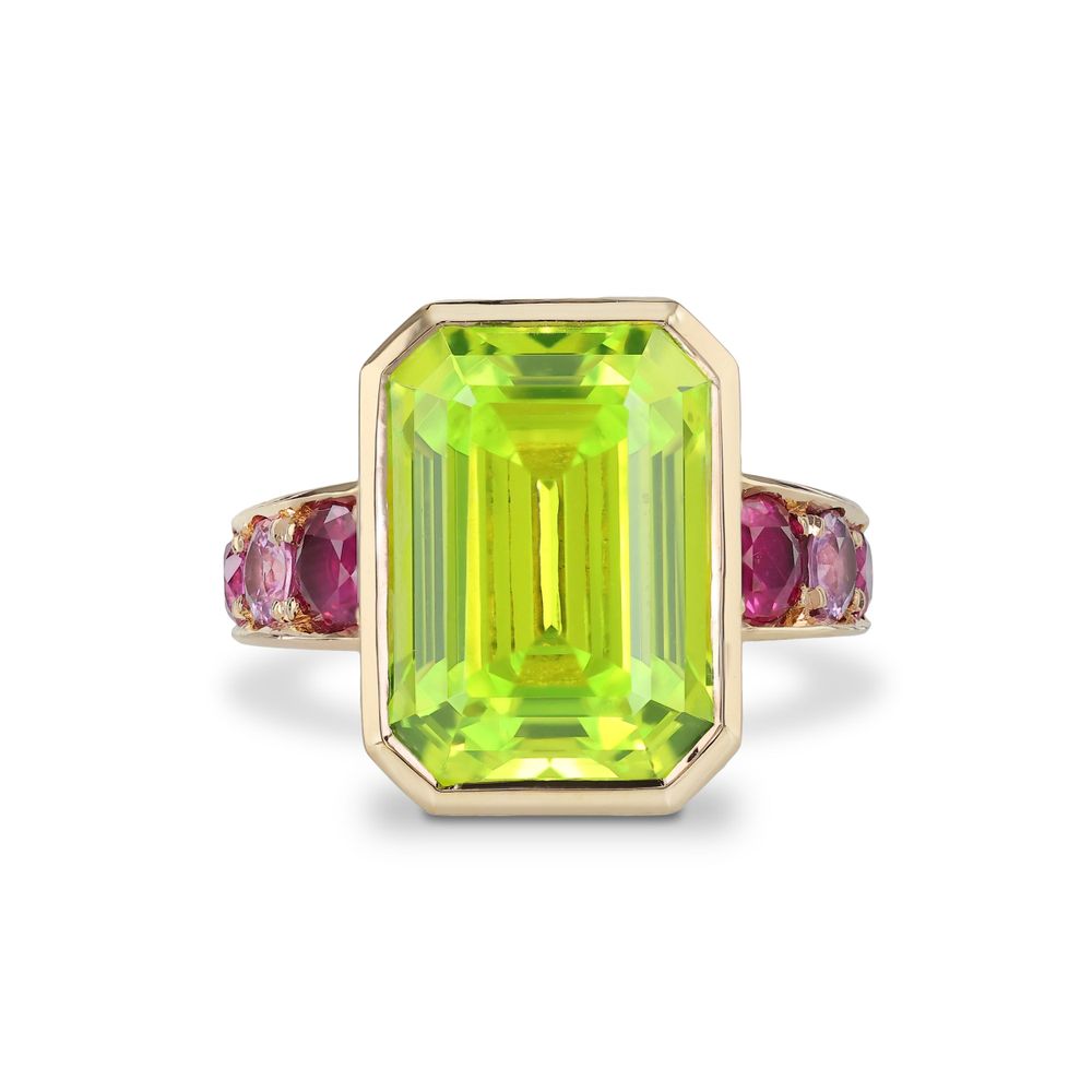 Statement ring featuring large emerald cut peridot center stone accented by pink side stones.
