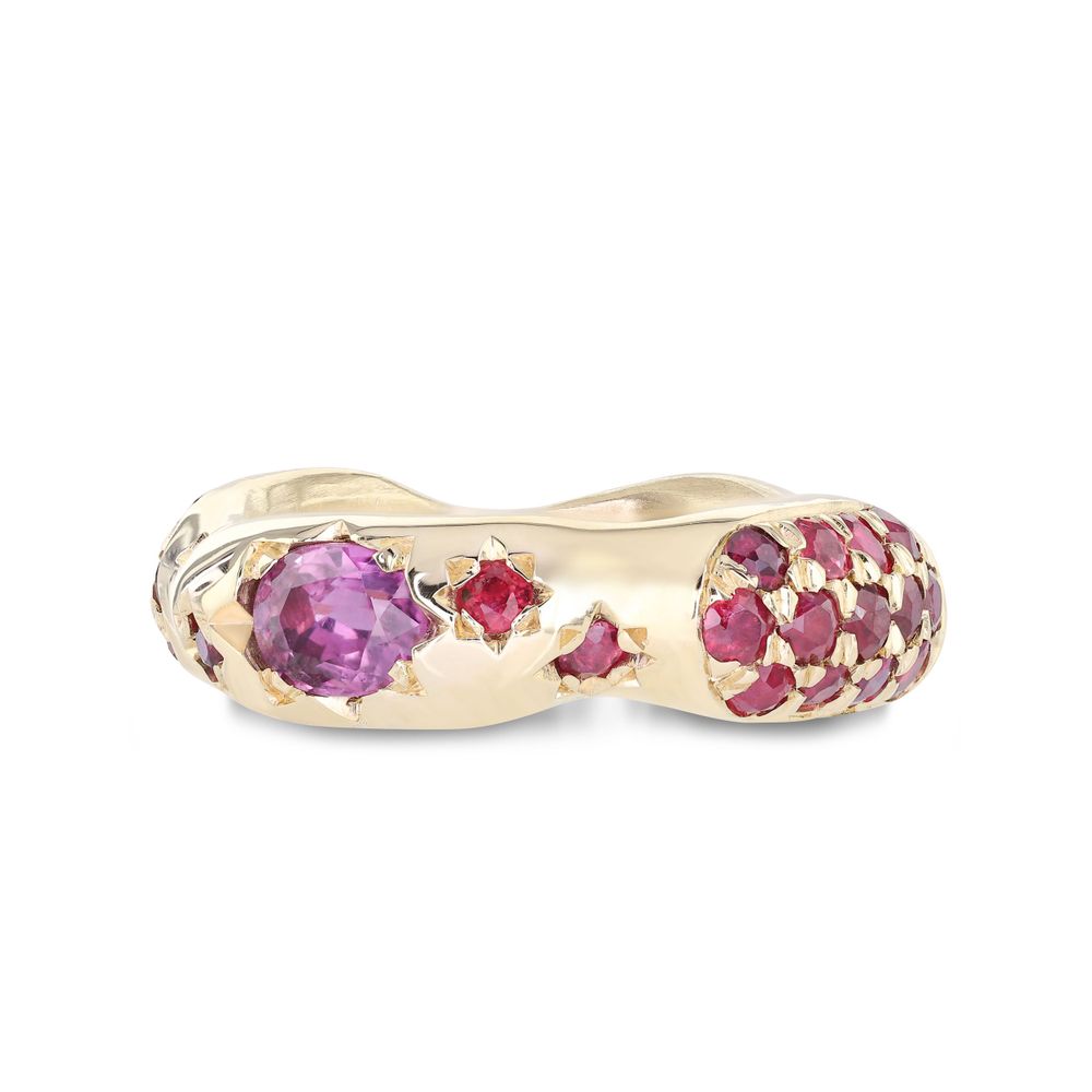 Gold ring featuring pink and purple gemstones in a curved wave design with graduated sizes of stones.