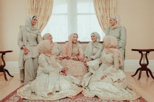 Group in coordinated modest attire gathered in elegant indoor setting with classic furniture.
