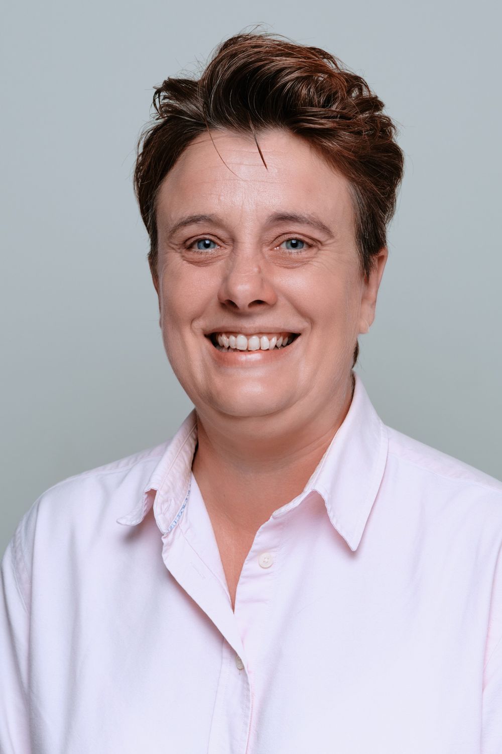 Professional headshot series showing different facial expressions against a light gray background.