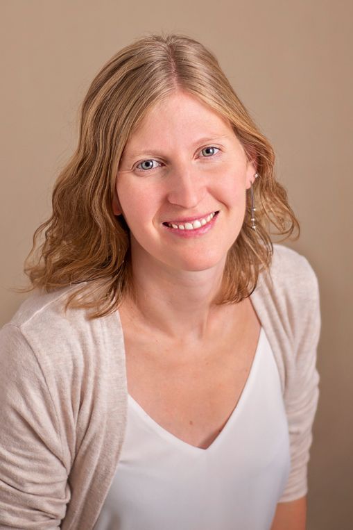 Nicole Turk Photography-owner-headshot, smiling in neutral tones in studio Cobourg, Ontario*