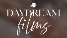 A white Daydream Films logo text floats in a dreamy blur against a dark brown background.
