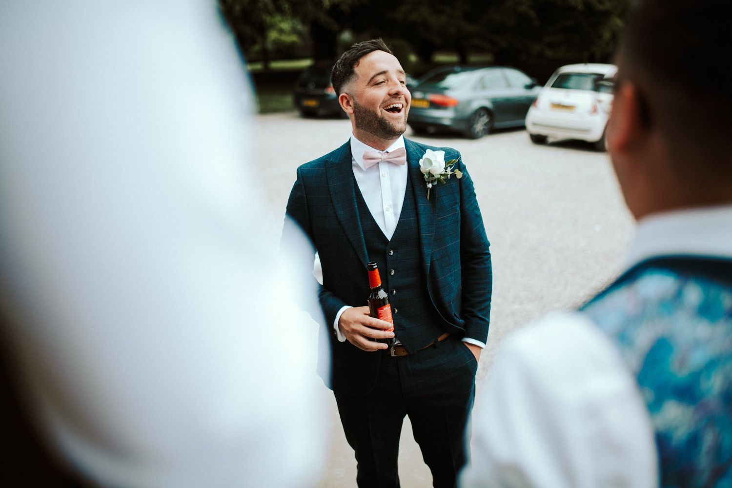 Wedding party members share laughs during outdoor formal photos. Saltmarshe Hall