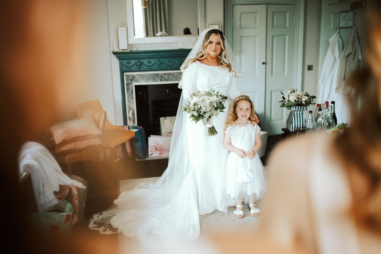 Sunlit bridal preparation room with flowing white curtains and elegant decor.