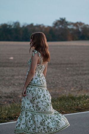 a girl spinning in circles on a backroad