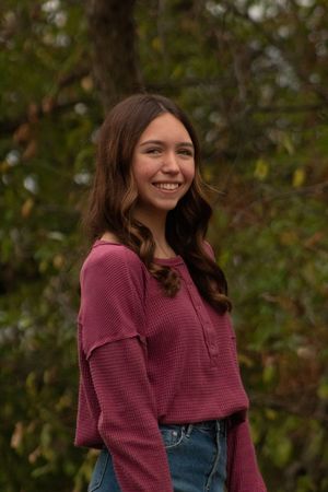 a girl posing in a wooded area