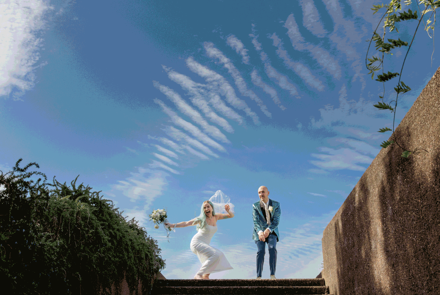 Auckland wedding photographer capturing a fun, energetic couple jumping and celebrating