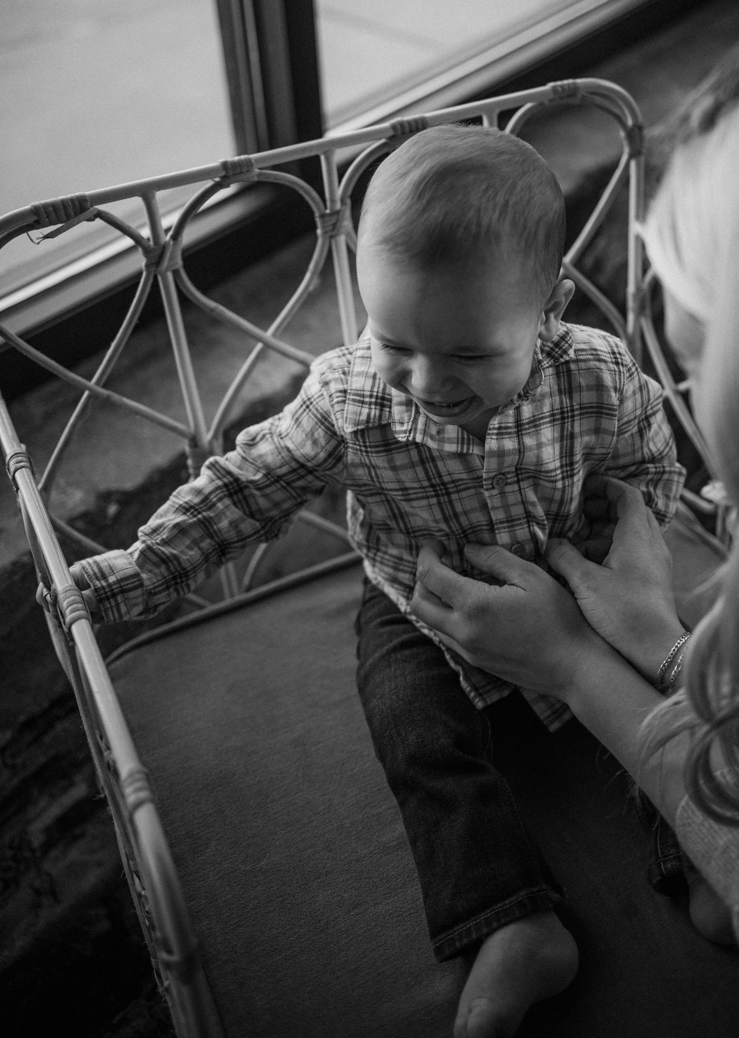 Black and white series of baby being held and comforted.