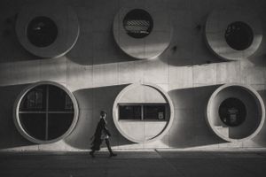 Black and white architectural photo showing circular windows in modern building design.