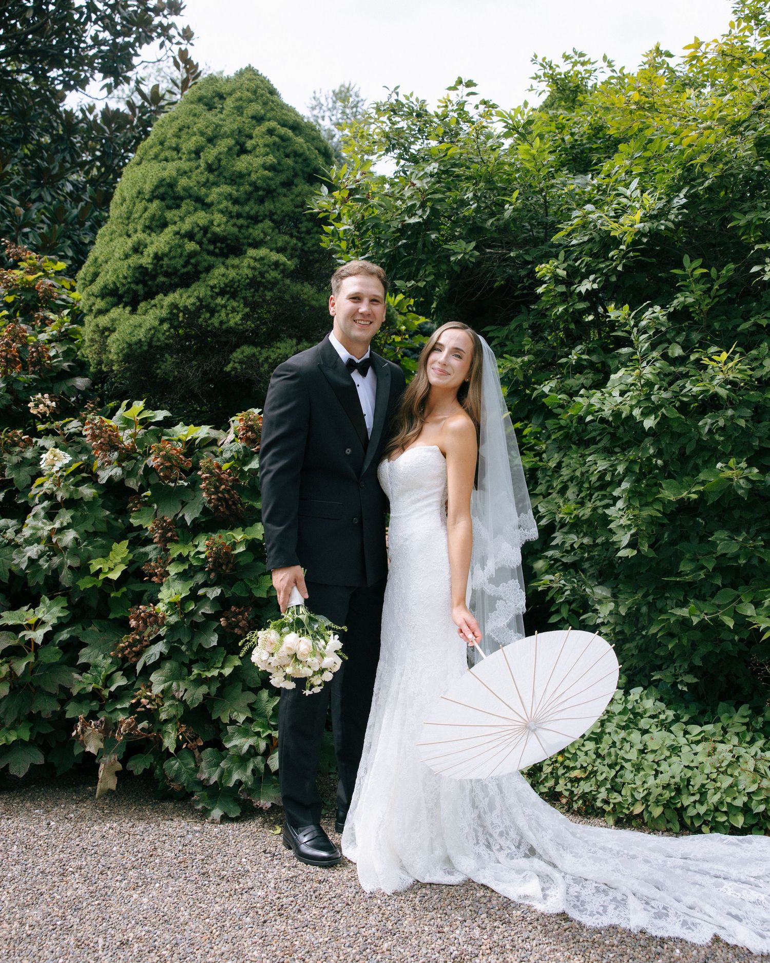 Elegant wedding website design with pale green and blush florals against a soft neutral background.