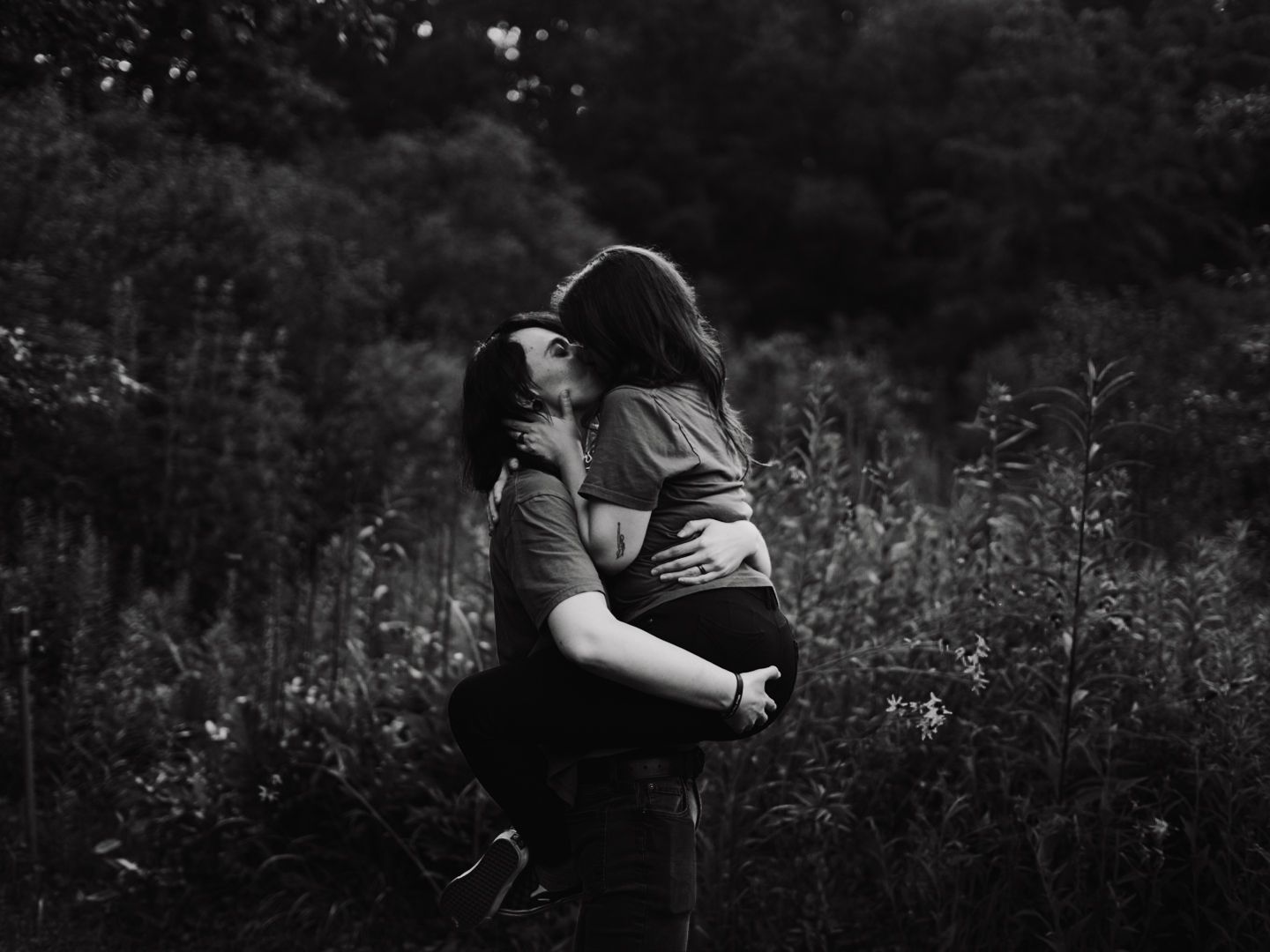 couple share kiss in field
