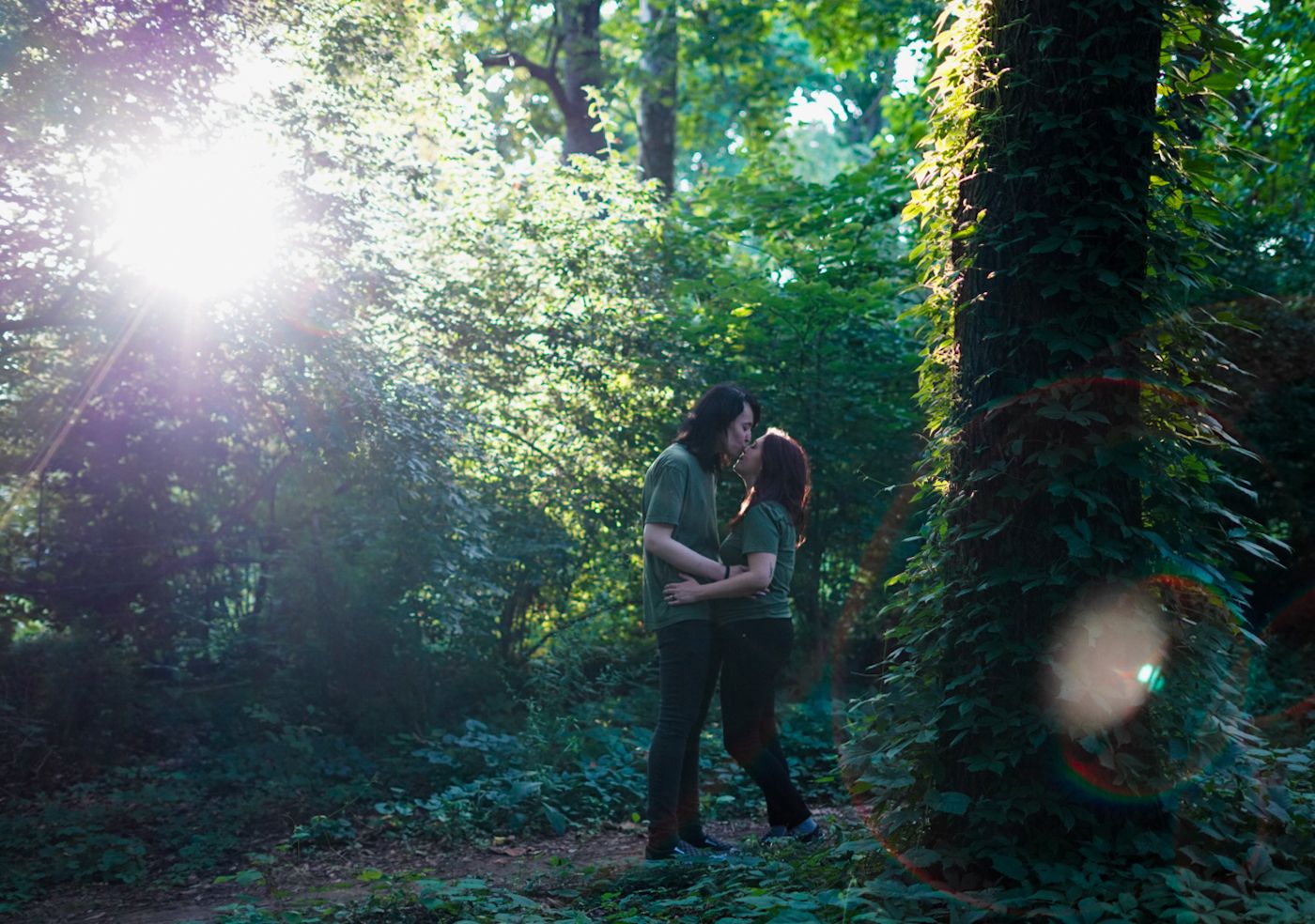 couple share kiss in woods