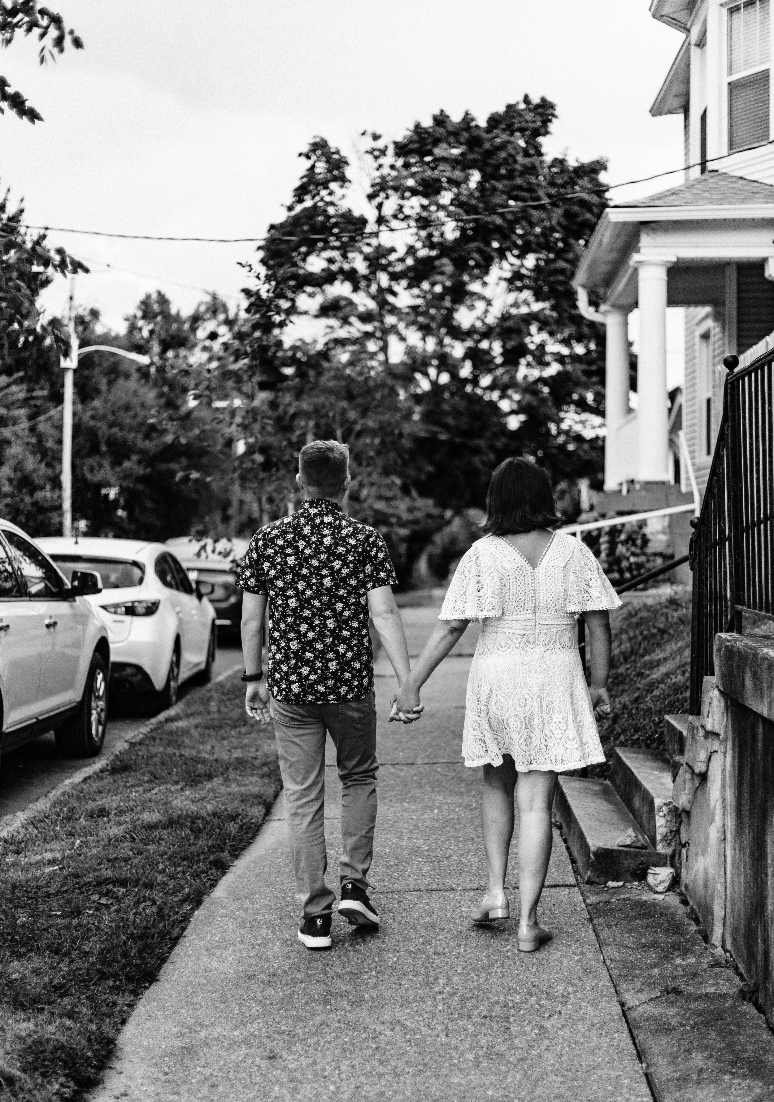 couple walking together down sidewalk