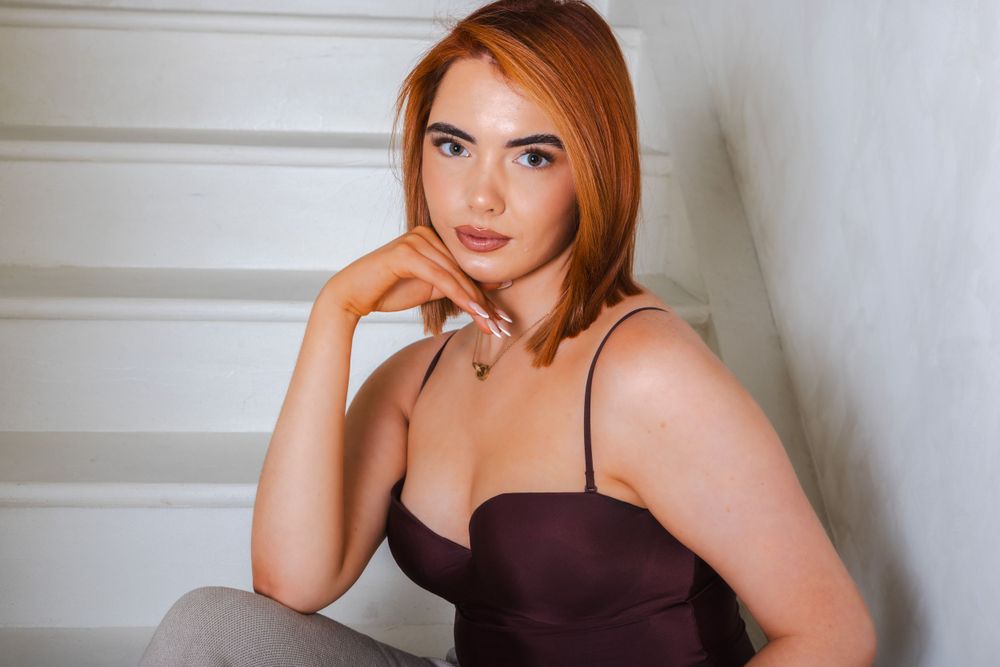 Fashion photoshoot featuring various poses in burgundy camisole and light colored pants.