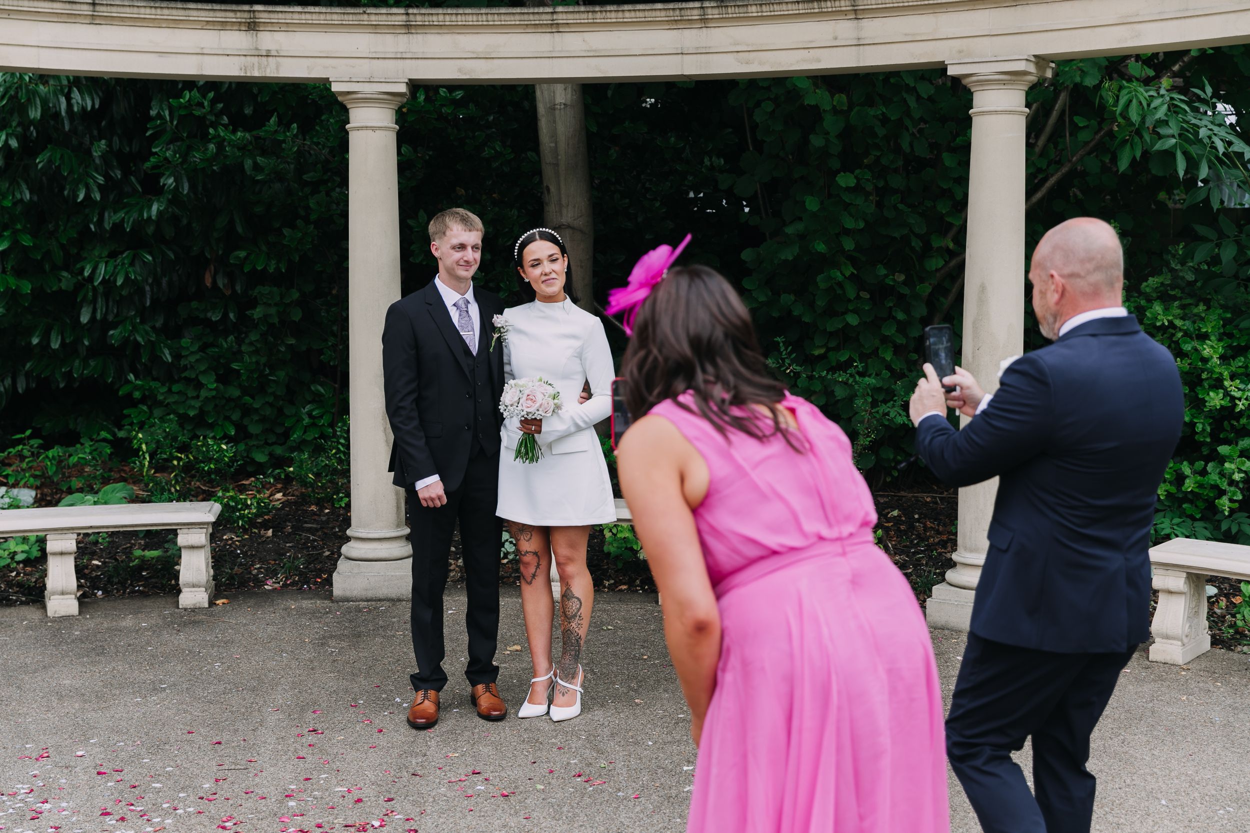 Wedding celebration scene under an outdoor colonnade with guests in formal attire.  Photographer. Hull. East Yorkshire. Photography