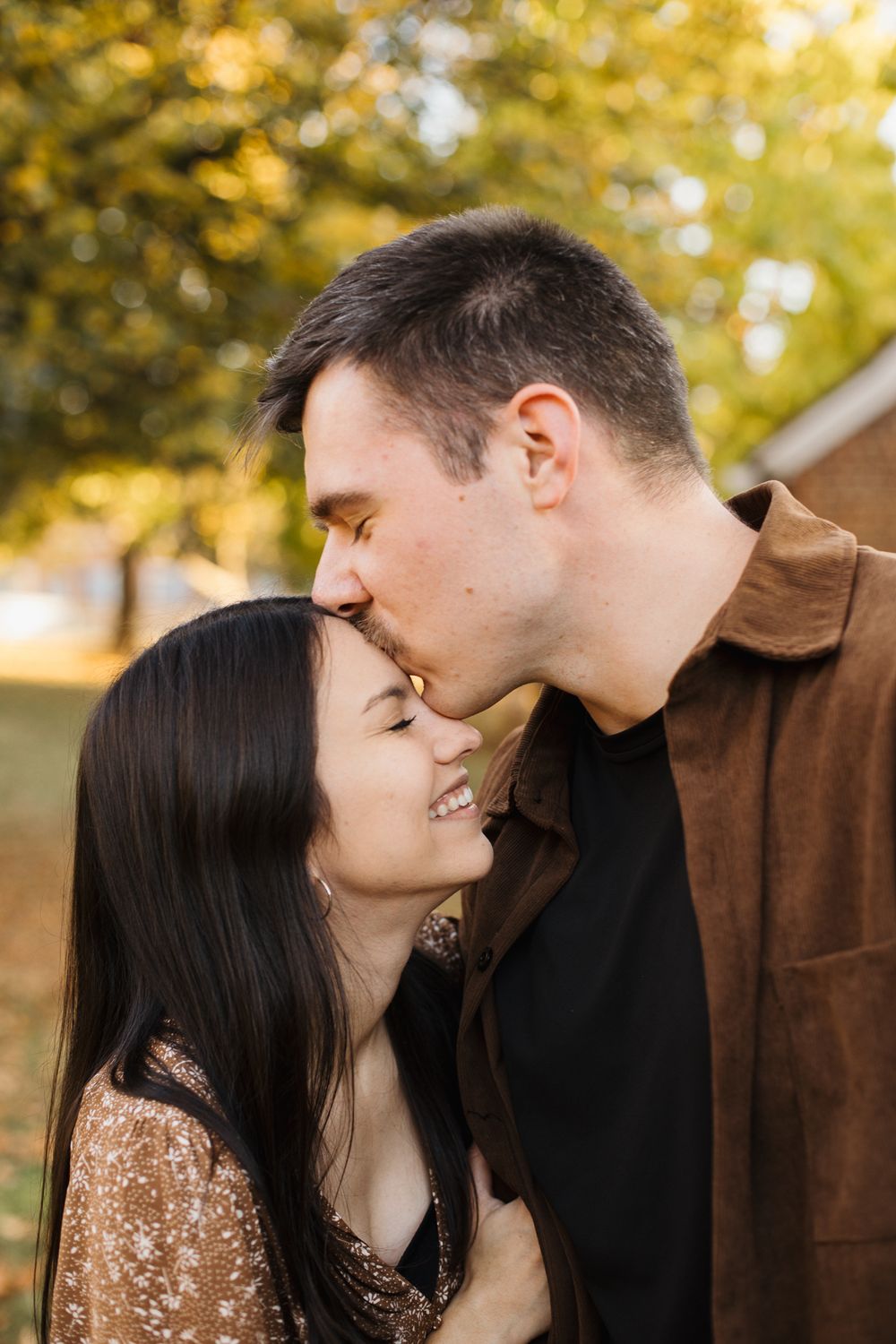 Close-up series of tender moments between couple against autumn foliage background.