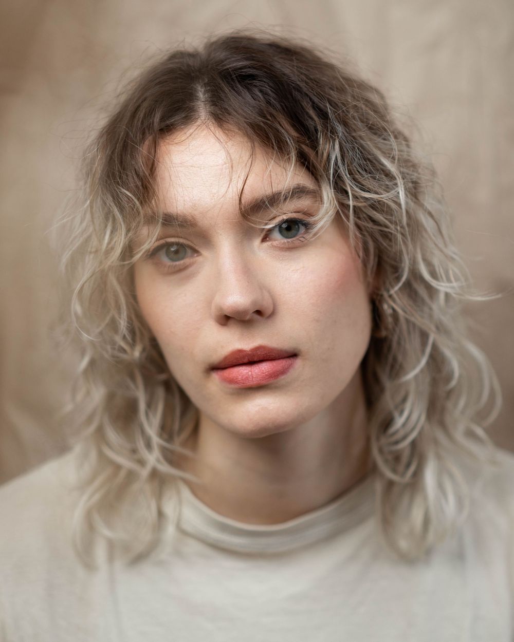 Portrait series showing ethereal lighting and soft focus on subject wearing light colored clothing.