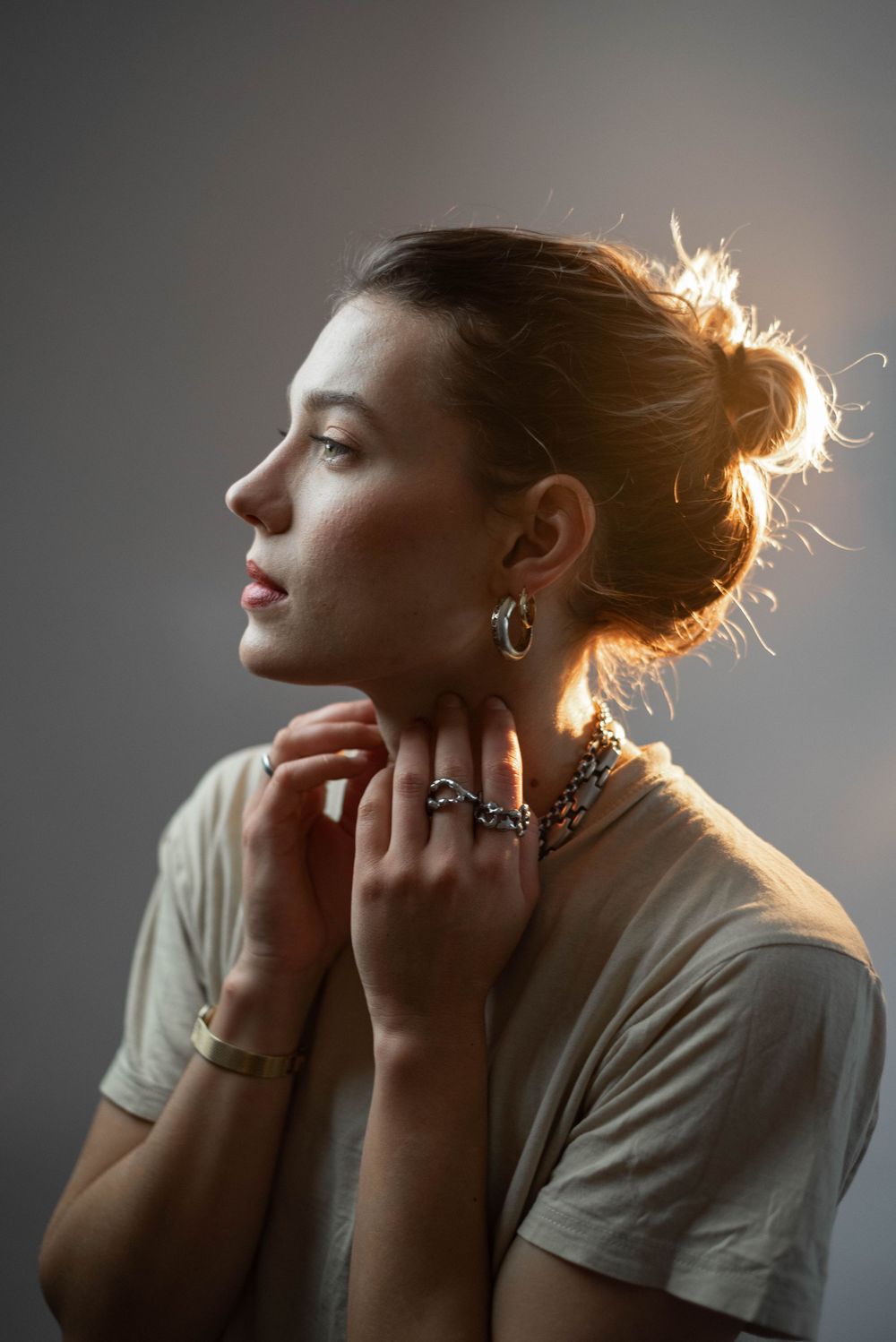 Dramatic side-lit portrait sequence showing contemplative poses against grey background.
