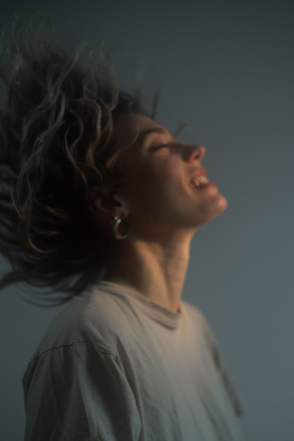 Moody silhouette portraits showing dramatic head movements in dark atmospheric lighting.