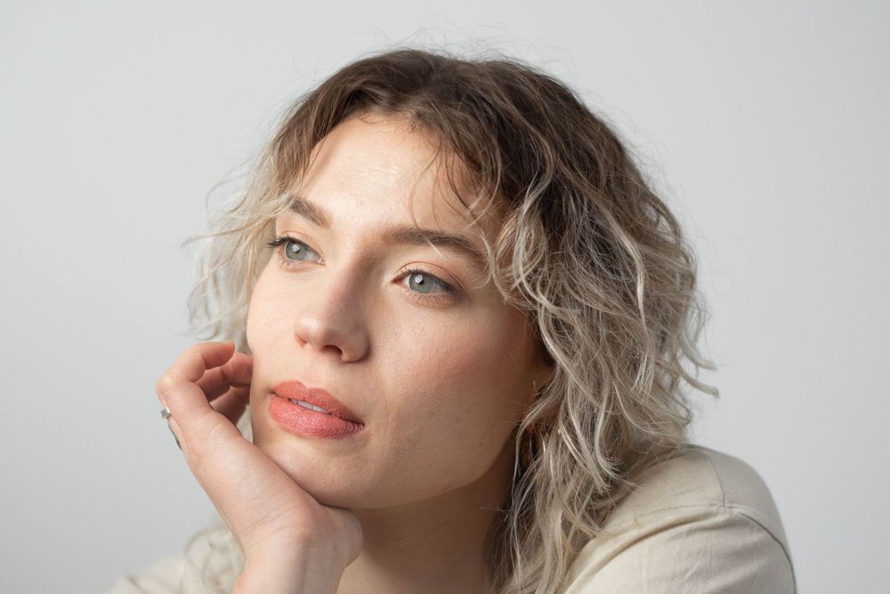 Light and airy portrait series showing playful expressions against white background.
