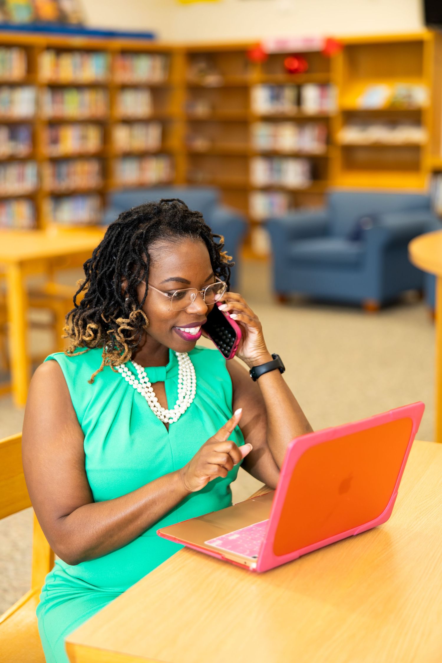 A series of photos showing someone in a green top working on an orange laptop in a library setting.
