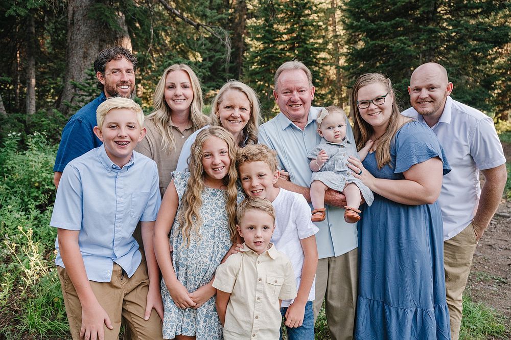 Multi-generational family portrait session in a wooded forest setting.