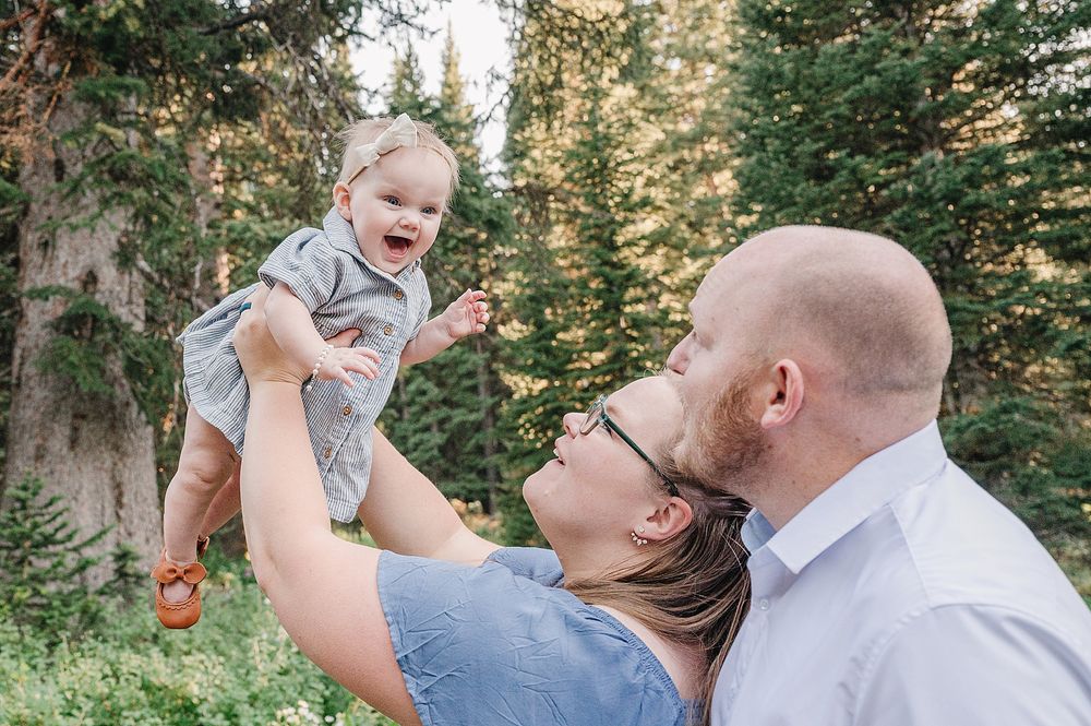 Joyful family interactions during a summer forest photo session.