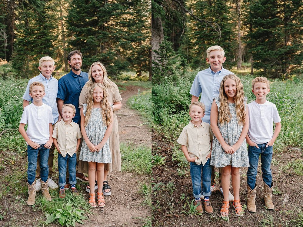 Group portrait of family members dressed in coordinated casual outfits standing on a forest trail.