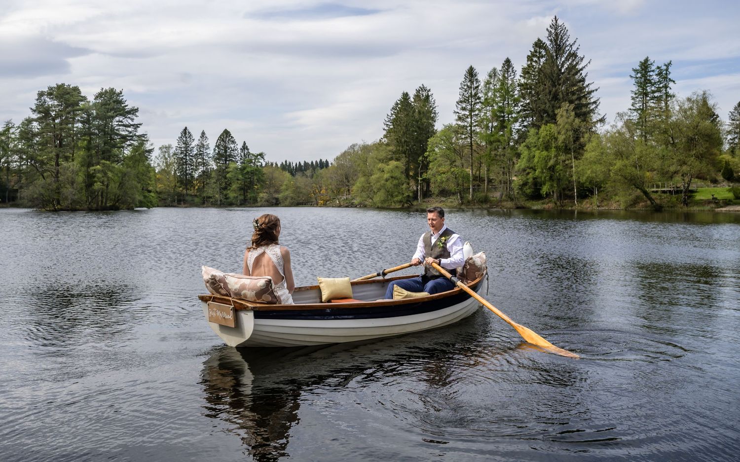 Newlyweds enjoying a rowing boat at the Gilpin Lake House
