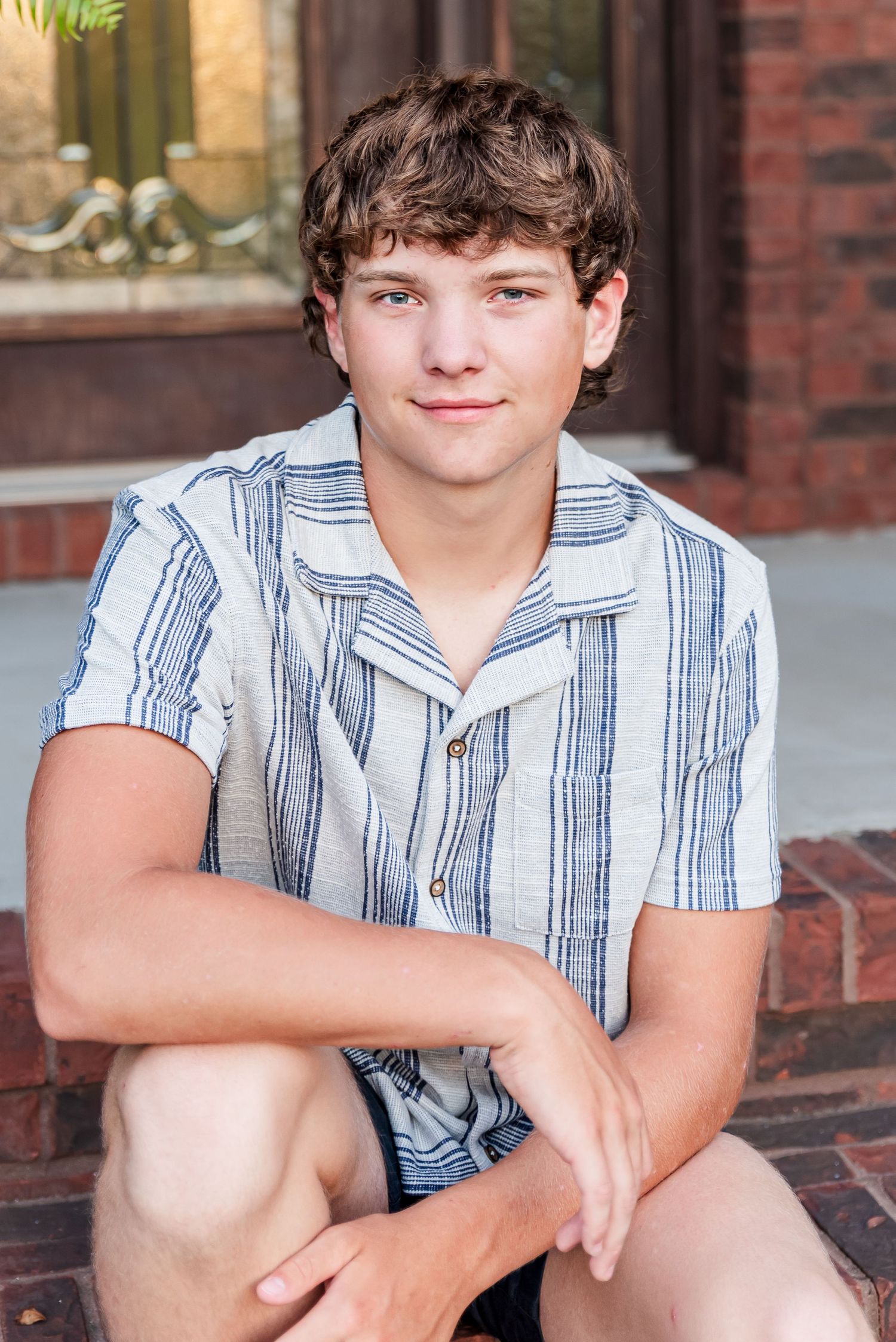Senior portrait of a boy smiling into the camera in Kuttawa, Kentucky.