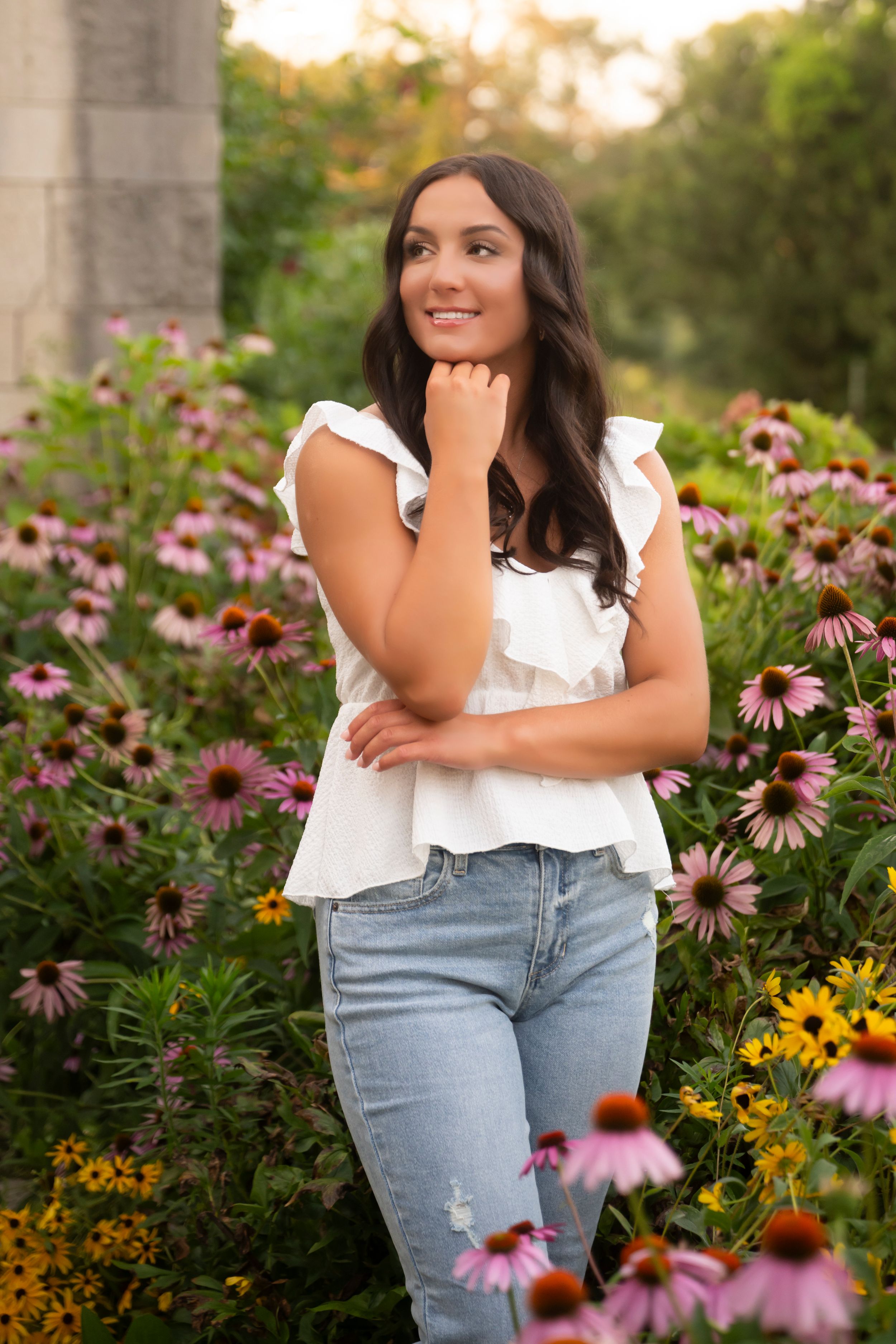 Beautiful garden setting with purple coneflowers and yellow blooms creating a natural backdrop at sunset.