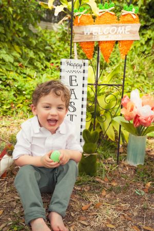 An Easter garden scene with decorative signs and festive spring decorations.