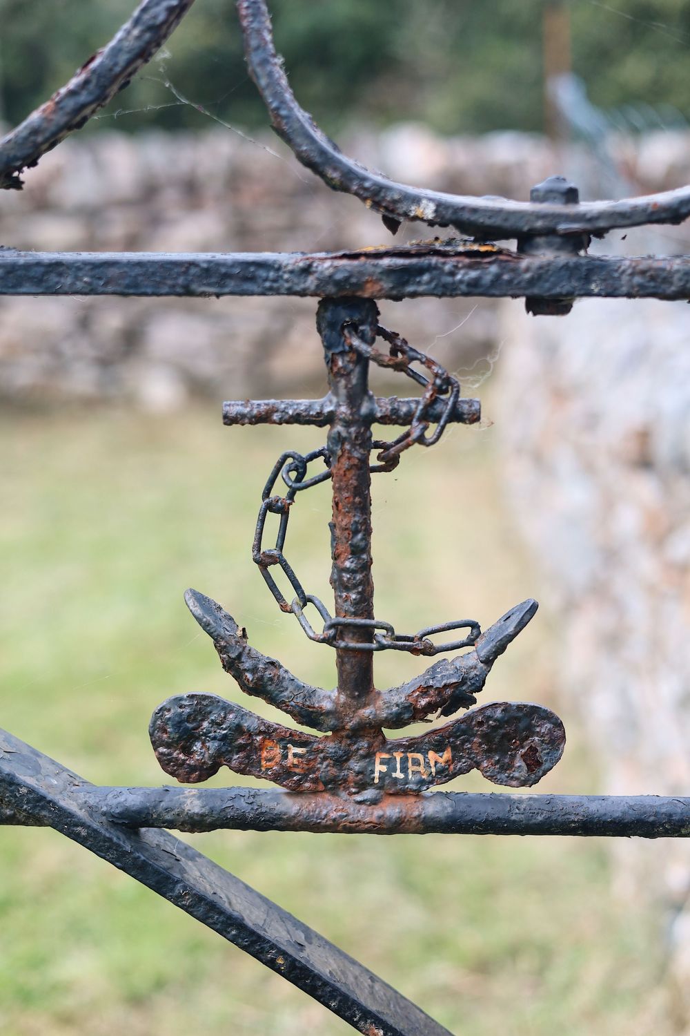 Multiple close-up views of a rustic metal door latch or garden gate fastener mounted on weathered branches.