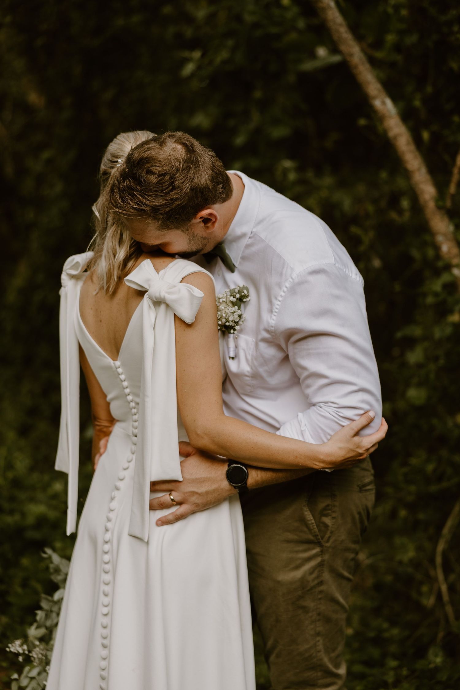groom carrying bride on shoulder