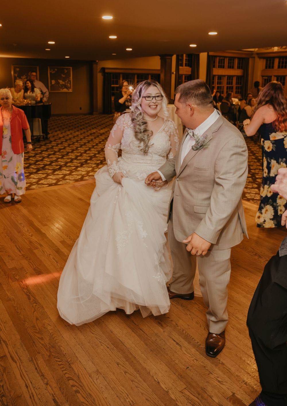 Bride and groom sharing first dance at elegant indoor wedding reception venue.