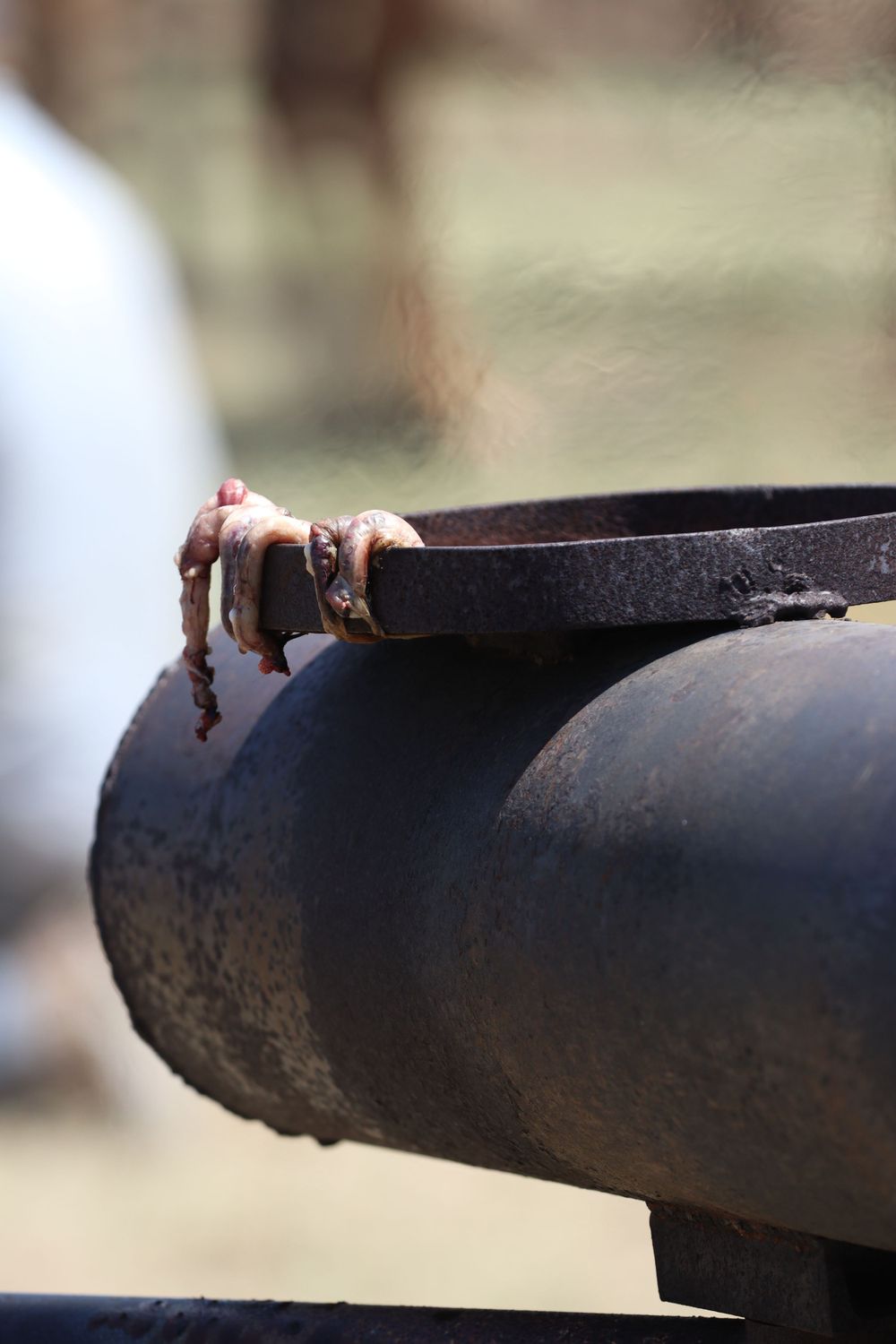 Close-up of a dark metal bracket or hardware against a blurred background.