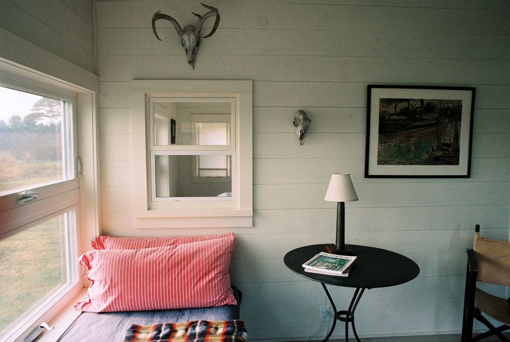 Custom couch and interior window in the Guest house at Harbor Cottage in Port Clyde, Maine.
