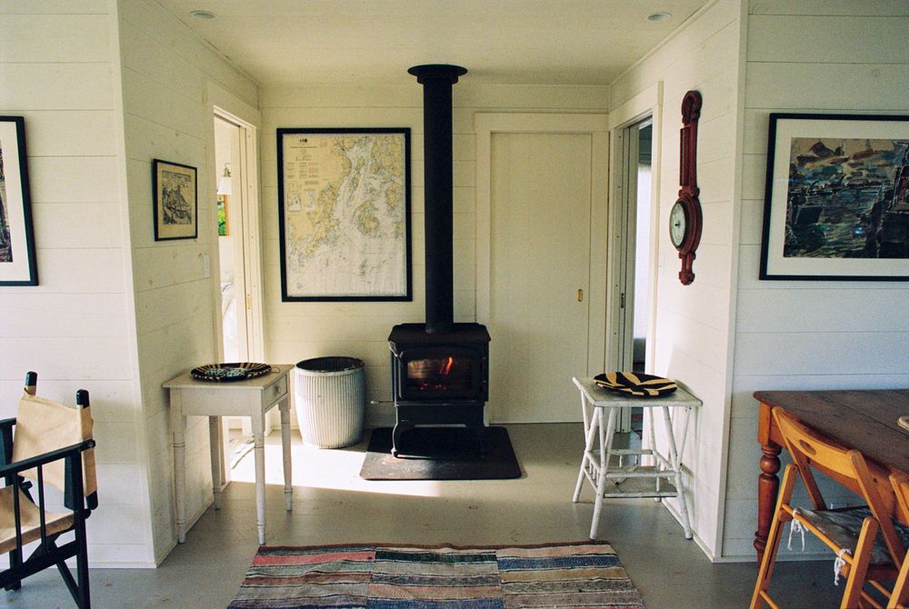 The wood burning stove and interior layout of the guest house in Martinsville, Maine.
